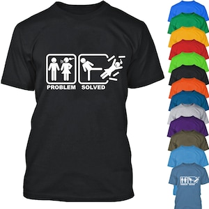May include: Black t-shirt with a white graphic of two stick figures. The first stick figure represents a woman with a thought bubble above her head. The second stick figure represents a man kicking the woman away. The graphic is labeled "Problem Solved".