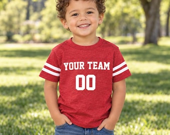 May include: A red short-sleeved t-shirt with white stripes on the sleeves. The front features the white text YOUR TEAM above the number 00 in a bold, block font. The shirt has a crew neckline and a heathered texture throughout the fabric.