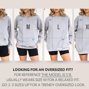 May include: Four images showcasing gray sweatshirts in sizes S, M, L, and XL, each worn by a model. Measurements are indicated in inches. Text at the bottom reads: "LOOKING FOR AN OVERSIZED FIT?" and provides sizing guidance.