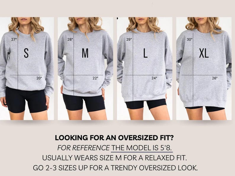 May include: Four images showcasing gray sweatshirts in sizes S, M, L, and XL, each worn by a model. Measurements are indicated in inches. Text at the bottom reads: "LOOKING FOR AN OVERSIZED FIT?" and provides sizing guidance.