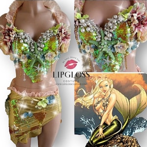 Pu&ograve; includere: Un set di costumi a tema sirena con un top di reggiseno in paillettes verde e oro, una gonna in paillettes oro e un abbellimento a forma di stella marina e perle. Il top di reggiseno ha un design floreale rosa e bianco. La gonna ha un design floreale rosa e blu. Il set &egrave; su un manichino. L'immagine include anche un disegno di una sirena.