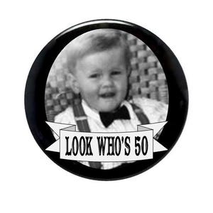 May include: Black and white photo of a young boy wearing a bow tie and a white shirt with the text "LOOK WHO'S 50" on a white banner.