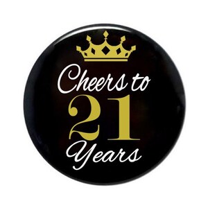 May include: Black button with a gold crown and the text "Cheers to 21 Years" in white.
