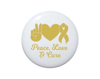 May include: A white button with a gold peace sign, heart, and ribbon. The text "Peace, Love & Cure" is written below the symbols.