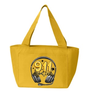 May include: Yellow lunch bag with a black and white graphic of a headset with the text "911 dispatcher" in a circle.