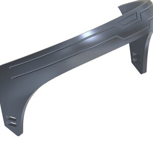 May include: A gray plastic headband with a curved design and geometric details. The headband has a smooth, matte finish.