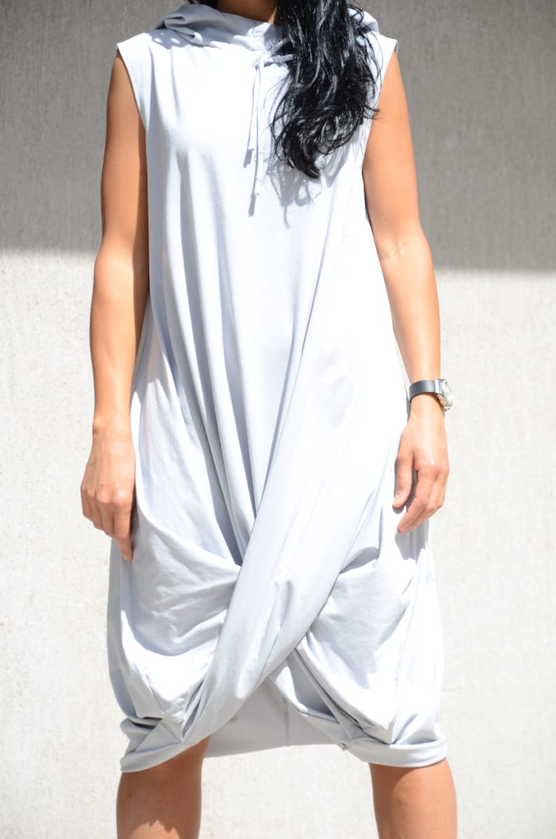 May include: A light gray sleeveless hooded dress with a gathered, loose fit.