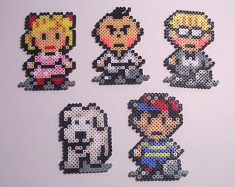 May include: A collection of five pixel art figures, including a girl in a pink dress, a boy in a white outfit, a boy with glasses, a dog, and a boy in a blue and yellow striped shirt. Each figure is made of small, colorful beads.