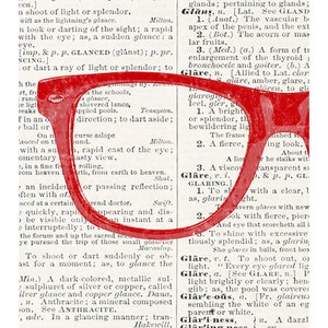 May include: A close-up of a red pair of glasses with a thick frame, partially obscuring a page from a dictionary. The dictionary page features the word "Glare" and its definition. The word "Glare" is highlighted in red.