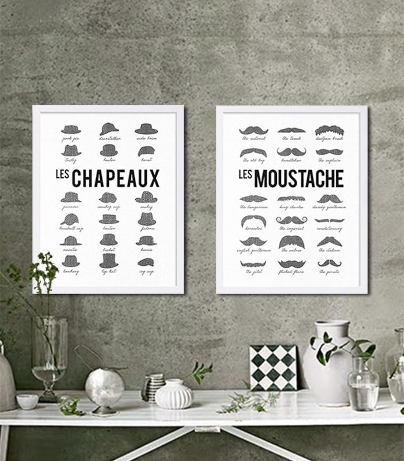May include: Two framed prints with black and white illustrations of different types of hats and mustaches. The top print is titled "LES CHAPEAUX" and the bottom print is titled "LES MOUSTACHE".