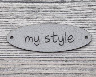 Kunstleren labels, grijs met de tekst "My style" - 10 stuks, ovaalvormig, om op te naaien, 2 gaatjes (Ø 1,5 mm), 8105