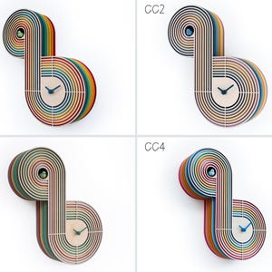 May include: Four colorful wooden clocks with a rainbow design. Each clock has a different color scheme and is labeled with the letters CC1, CC2, CC3, and CC4.