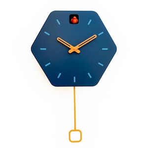 May include: A blue hexagonal cuckoo clock with a gold pendulum and gold hands. The clock face has blue hour markers and a small red bird on top.
