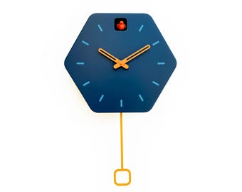 May include: A blue hexagonal cuckoo clock with a gold pendulum and gold hands. The clock face has blue hour markers and a small red bird on top.