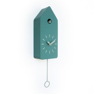 May include: A teal blue cuckoo clock with a pendulum and a birdhouse design. The clock face has black Roman numeral hour markers and silver hands.