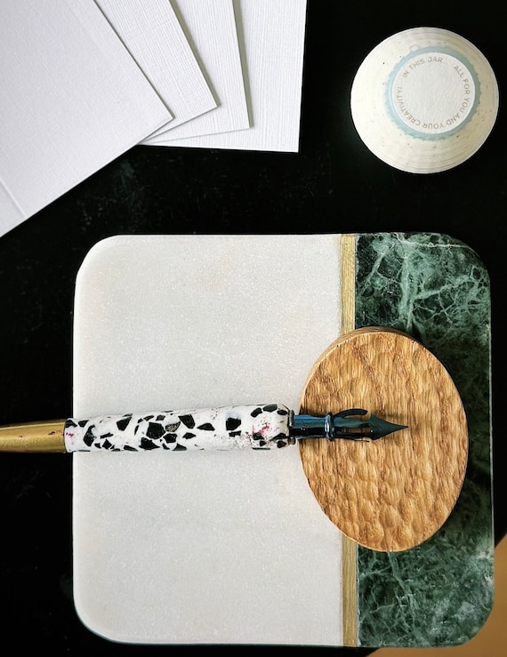 A minimal sculpted oak pen rest with a Japanese-inspired name and a calligrapher's sensibility — the kind of small object that elevates an entire desk.