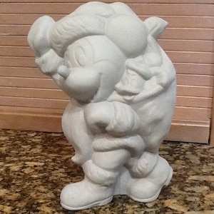 May include: White ceramic figurine of a cartoon character carrying a sack on their back. The character is wearing a hat and has a large nose.