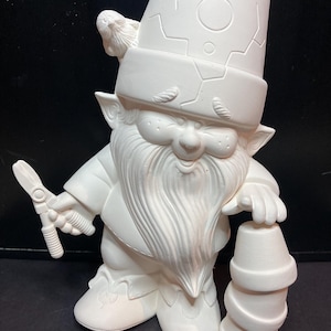 May include: A white ceramic garden gnome figurine holding gardening shears and a stack of three flower pots. The gnome has a long beard, a hat with a bird on top, and is ready to be painted.