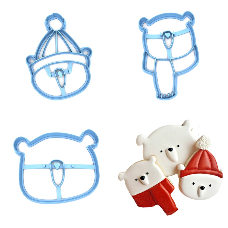 May include: Set of four blue plastic cookie cutters shaped like polar bears wearing winter hats and scarves. Two cutters are of a bear wearing a hat, one is of a bear wearing a scarf, and one is of a bear wearing both a hat and scarf.