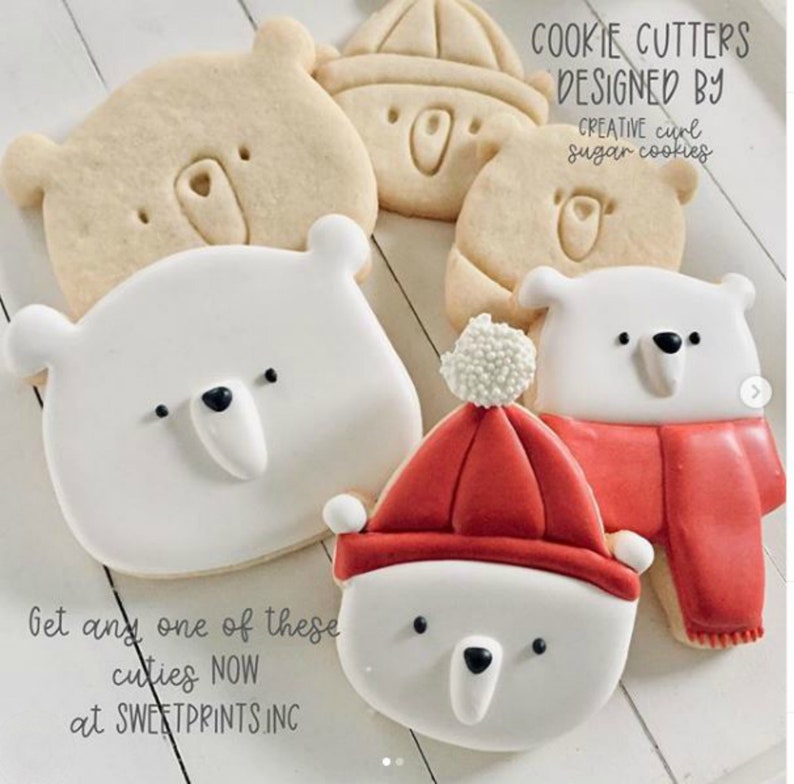 May include: Set of five cookie cutters featuring polar bear designs. The cutters include a polar bear wearing a red hat, a polar bear with a scarf, and three different polar bear faces. The text "COOKIE CUTTERS DESIGNED BY CREATIVE curl sugar cookies" is visible in the image.