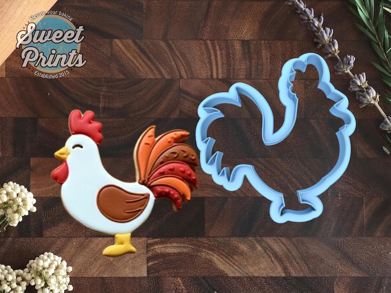 May include: A rooster-shaped cookie decorated with white icing, a red comb and wattle, a yellow beak, and a brown wing with a multi-colored tail in shades of orange, red, and brown, alongside a light blue plastic rooster-shaped cookie cutter.