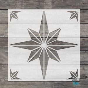May include: White stencil of a large, geometric star with eight points. The star is made up of many smaller triangles. The stencil is on a wood background.