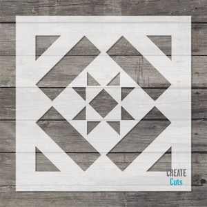 May include: White stencil with a geometric design of squares and triangles. The design is similar to a quilt pattern. The stencil is on a wood background. The text "CREATE Cuts" is in the bottom right corner.