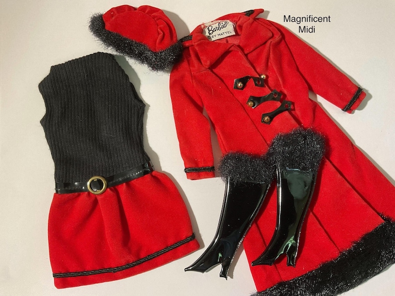 May include: A doll clothing set labeled Magnificent Midi including a red velvet coat with black faux fur trim, a black sleeveless ribbed top, a red skirt with a black belt, a red beret with black faux fur trim, and a pair of black patent boots.