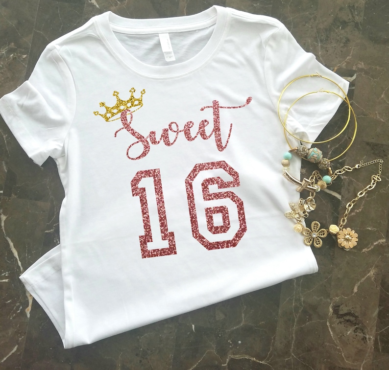 May include: White t-shirt with a gold crown and the words "Sweet 16" in pink glitter.