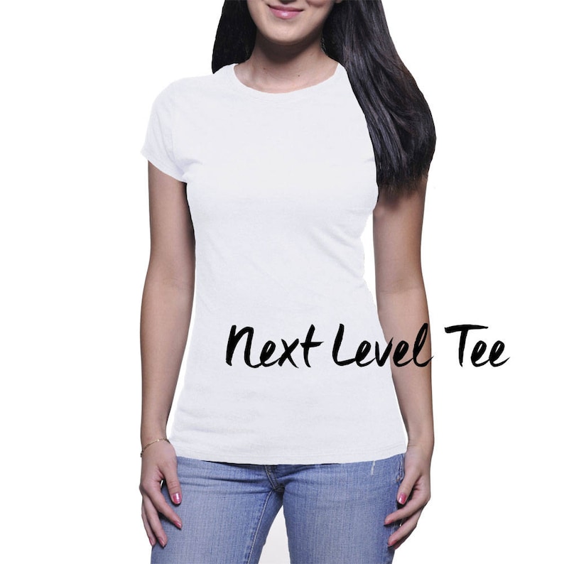 May include: A white t-shirt with the text "Next Level Tee" printed on the front.