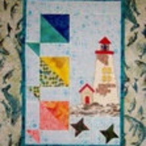 May include: A colorful patchwork quilt featuring a lighthouse with a red roof and a small house next to it. The quilt is surrounded by a border of blue dolphins on a light brown background.