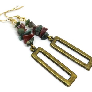 May include: Gold dangle earrings with a rectangular frame and a long strand of multi-coloured gemstone beads.