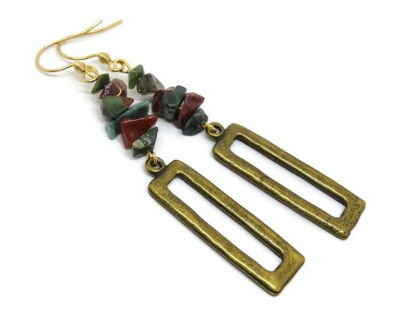 May include: Gold dangle earrings with a rectangular frame and a long strand of multi-coloured gemstone beads.