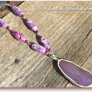 May include: A purple agate pendant necklace with a silver chain and purple and white patterned beads.  MyCreativeSideJewels.etsy.com