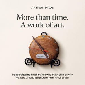 May include: A handcrafted wooden clock with a brown mango wood face and solid pewter markers. The clock has a black metal stand and features the text "More than time. A work of art."