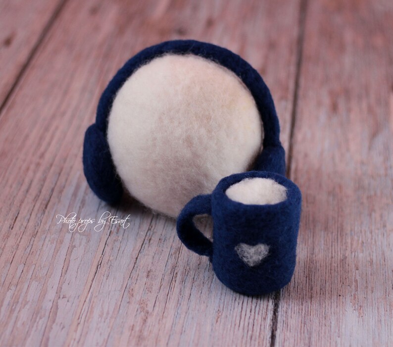 May include: A white felt ball with blue felt earmuffs and a blue felt mug with a white heart design.