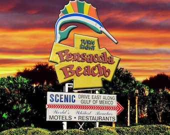 The iconic Pensacola Beach sign at sunset.