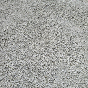 May include: A close-up view of a pile of small, white, round gravel. The gravel is evenly distributed and appears to be dry.