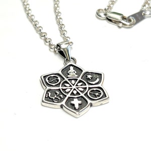 May include: Silver necklace with a pendant featuring a flower with eight points. Each point has a different symbol representing a different religion. The symbols include a cross, a star of David, a crescent moon, a peace sign, a yin yang, a Buddhist symbol, and two other symbols.