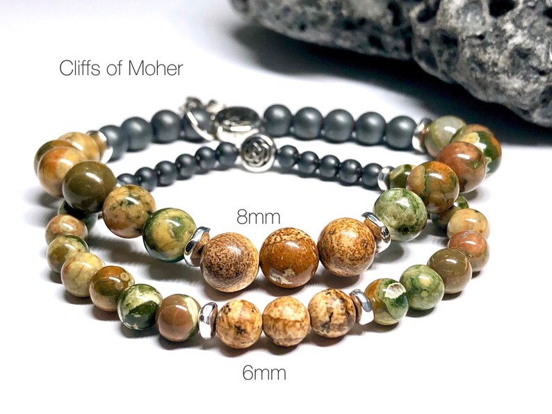 May include: Two bracelets made with green, brown, and white patterned stones. The smaller bracelet has 6 mm beads and the larger bracelet has 8 mm beads. The text "Cliffs of Moher" is visible in the image.