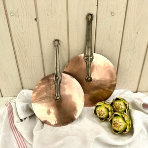 May include: A rustic wooden sign with the text "Welcome to our home" in white lettering. The sign has a distressed finish and a simple, inviting design, ideal for front door decor.