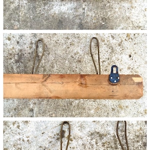 May include: A wooden shelf with five metal hooks. The hooks are attached to the shelf with metal rings. The shelf is made of natural wood and has a rustic look.