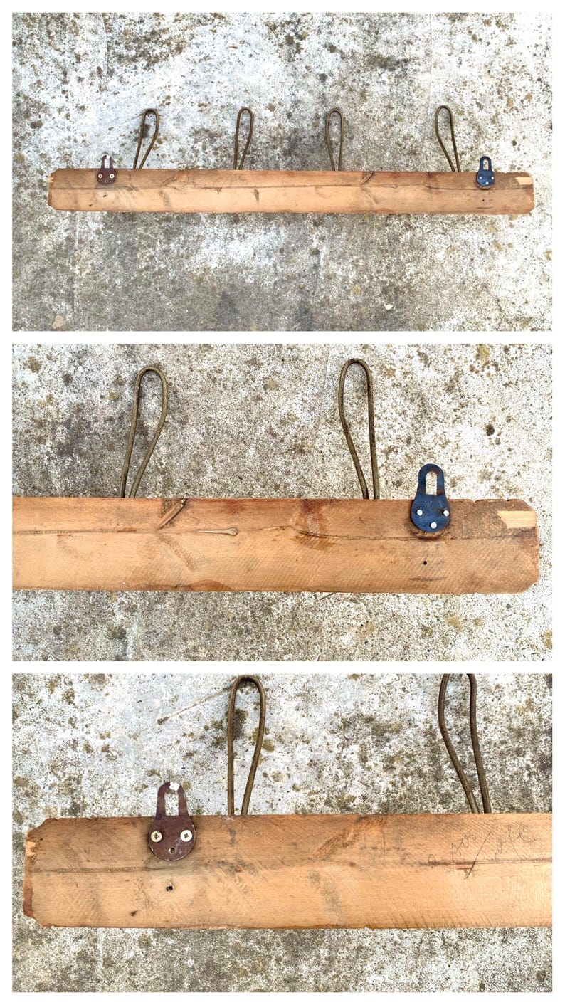 May include: A wooden shelf with five metal hooks. The hooks are attached to the shelf with metal rings. The shelf is made of natural wood and has a rustic look.