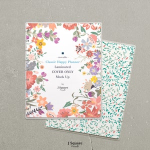 May include: A white planner cover with a floral design. The cover is laminated and has a movable disc system. The text on the cover reads "Classic Happy Planner Laminated COVER ONLY Mock Up by J Square Presents".