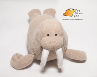 May include: A plush brown walrus toy with white tusks. The toy is lying on its belly with its flippers outstretched.