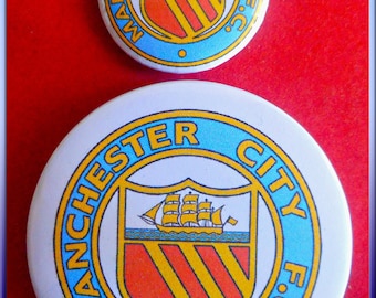 Two Manchester City Football Club Pin Badges. 1 Standard Size & 1 Large.  Free Mailing to Any Location.