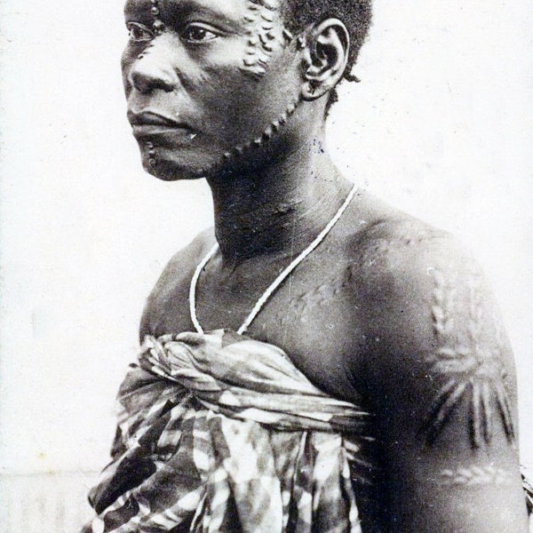 Reprinted Tinted Postcard Photograph of Belgium Congo Central African Woman With Tribal Skin Decoration. An Ethnic Photo Circa 1910s