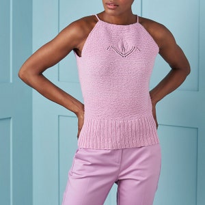 May include: A sleeveless, light pink knitted top with a delicate lace pattern on the front. The top has a halter neckline and a fitted silhouette.