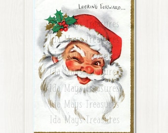 May include: A vintage-style greeting card featuring a winking Santa Claus with a white beard and a red hat adorned with green holly leaves and red berries. The text "Looking Forward..." is printed in black at the top of the white card.