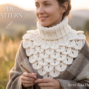 May include: A cream-colored crochet cowl featuring a ribbed turtleneck collar and a layered, scale-like stitch pattern. The text PDF PATTERN is visible in the upper left corner, and the text ivon-Kaa Design is in the lower right corner.